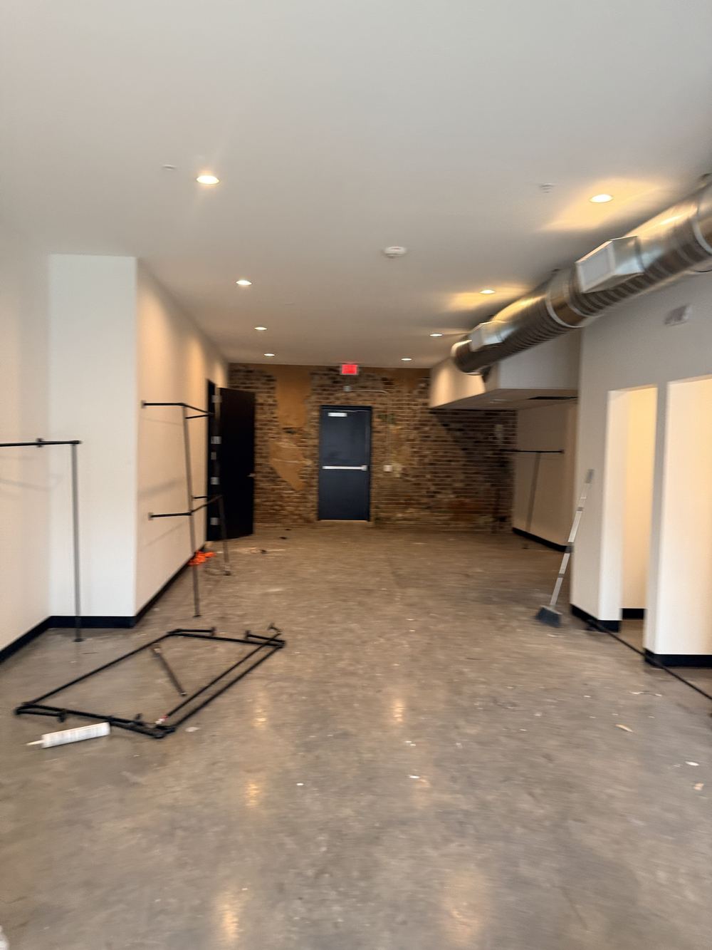 Commercial interior painting with scaffold and scissor lift on high vaulted ceiling