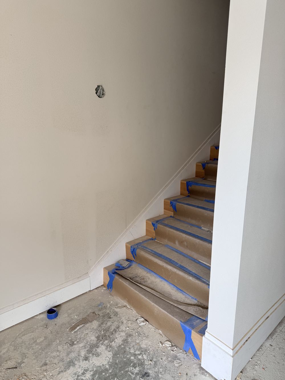 Commercial stairwell prepped and taped for painting or staining